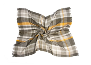 Macro detail of plaid pattern texture and fringed edges on the yellow and grey scarf