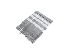 Close-up of classic grey and white plaid scarf with fringe tassels for winter warmth