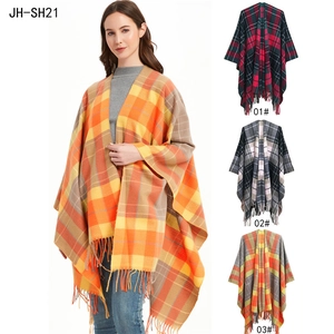 Detail showing various plaid patterns and soft fringe trim on these winter shawls