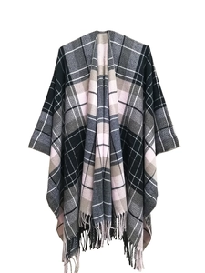 Detail of plaid shawl with fringe hem and soft acrylic knit texture in grey and pink