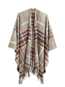 Detail of classic plaid shawl with fringe tassels in brown beige and light blue tones