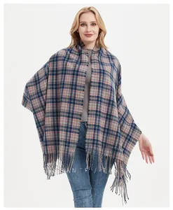 Detailed close-up of thick plaid scarf with tassels in blue, pink, and gray colors