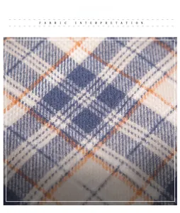 Macro detail of soft thick plaid scarf fabric in navy blue cream and orange with fringe