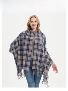 Detail of soft tassel fringe on thick plaid shawl in navy blue and dusty pink check