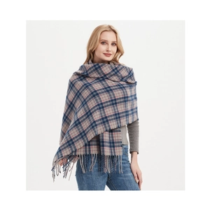Detail view of thick blue and pink plaid scarf with tassels styled as a cozy shawl wrap