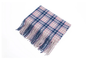 Close-up of thick plaid scarf in pink, navy, and beige with soft fringe tassels