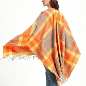 Women's plaid tassel shawl cape in orange and grey pattern with fringe details