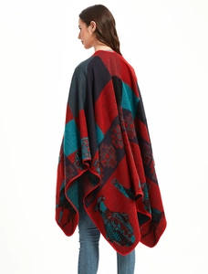 Detail of knitted winter shawl featuring ethnic animal motifs and thick red edge stitching