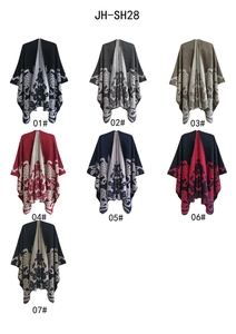 Detail view of seven color patterns for thick jacquard knit ponchos with reindeer motifs