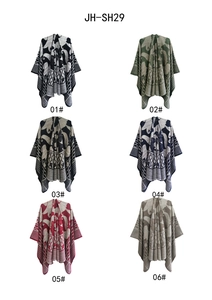 Multi-color jacquard knit ponchos featuring geometric patterns and fringe detail