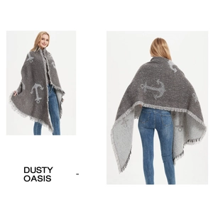 Close-up of anchor jacquard pattern and long tassels on gray winter knitted shawl