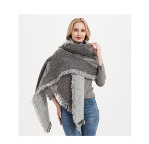 Detail shot of the thick boucle yarn texture and frayed edges on this grey anchor shawl