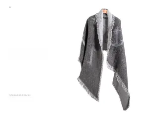 Detail of grey thick scarf featuring double-sided anchor pattern and fringe tassel edges