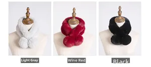 Detailed view of fluffy faux fur scarves in light grey, burgundy, and black with pom-poms