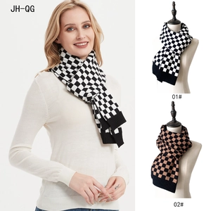 Detailed close-up of thick knitted checkered scarf in black-white and black-brown colors
