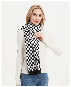 Macro view of checkered knit scarf texture with ribbed edges and black and white pattern