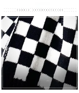 Close-up of thick black and white checkerboard knit fabric showing soft yarn texture
