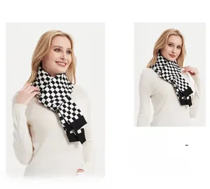Detail of black and white checkerboard knit scarf showing thick knitted texture and pattern