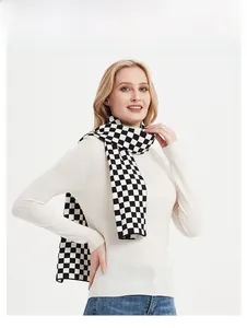 Detail of classic black and white checkerboard knit scarf with thick elastic texture