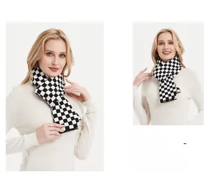Detail of the thick checkered knit texture and soft yarn on the black and white scarf