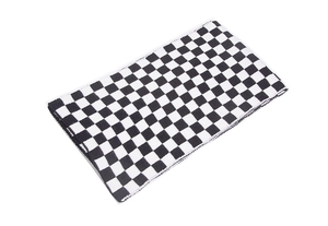 Detail shot of black and white checkerboard knit scarf showing soft fabric texture