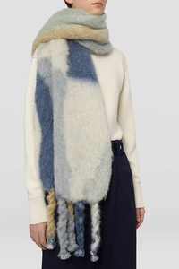 Detail of color-block scarf with thick braided tassels and plush knit texture