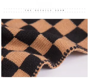 Macro shot of the black and yellow checkered knit scarf showing soft fabric texture