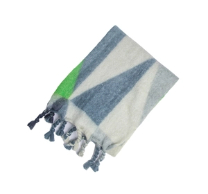 Detail of knit scarf with geometric triangles, soft brushed texture and twisted tassels