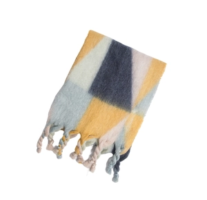 Detail of thick winter scarf with geometric color blocks and hand-twisted tassels