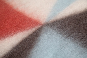 Macro shot of thick textured scarf showing geometric pattern and soft plush fibers