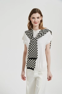 Detail of checkered knit pattern on a decorative black and white knot shawl