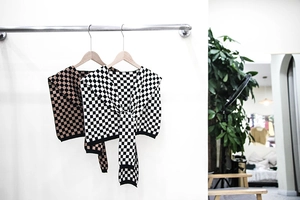 Detail of checkered knit shawl with soft texture and stylish tie-front design