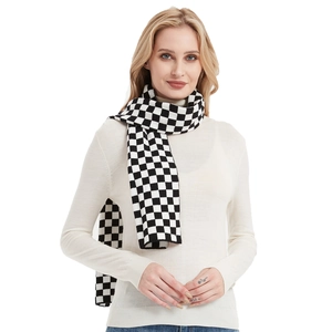 Classic black and white checkerboard knitted scarf styled on a model in winter outfit