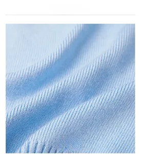 Macro shot of light blue knitted fabric detail with vertical ribbed texture and soft feel