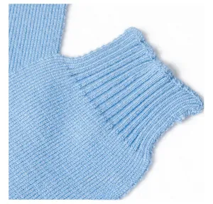 Close-up of light blue knitted shawl fabric showing detailed ribbed texture and elasticity