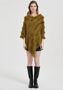 Detail of knitted olive shawl featuring thick textured ridges and long fringe tassels