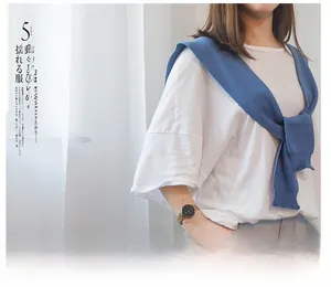 Blue knitted shoulder shawl draped over a white short sleeve t-shirt for women