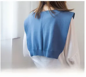 Detail of blue knitted fake collar shawl showing ribbed hem and layered back view