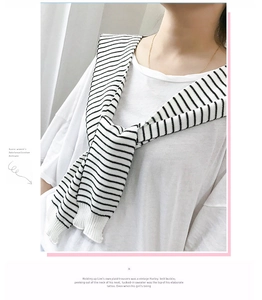 Close-up of black and white striped knit shawl accessory with detailed weaving texture