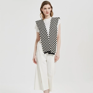 Chic black and white checkerboard knitted shawl cape for women, stylish layered casual look