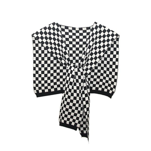 Classic black and white checkerboard knit shawl wrap with knotted front design