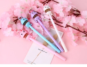 Close-up of cute cartoon rabbit spring pens in four pastel colors with cherry blossom decor