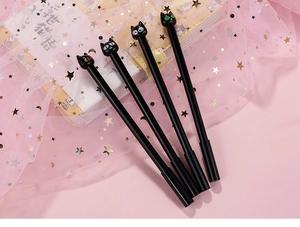 Detailed set of four black cat gel pens with colorful 3D cat head caps on pink mesh background