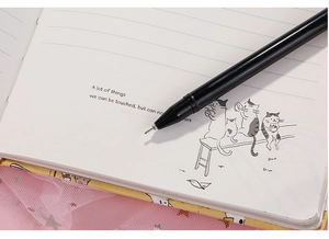 Close-up of cat-themed notebook with lined paper and matching black gel pen stationery