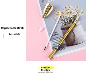 Detail of golden metal dart pen with refillable ink and arrow target pattern design