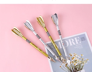 Creative arrow-shaped gel pen set in gold and silver finish on decorative background