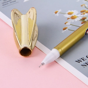 Golden creative dart gel pen with wing-shaped cap on decorative background