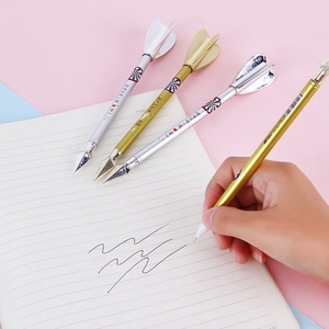 Creative gold and silver dart-shaped gel pens with needle tips writing on a notebook