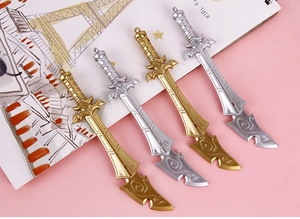 Detailed view of sword-shaped pens in gold and silver finish with embossed patterns