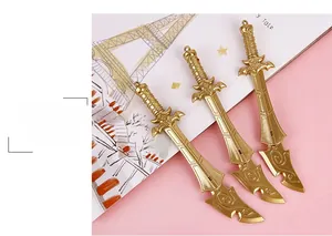 Detailed macro of golden sword pens with intricate floral engravings on the hilts